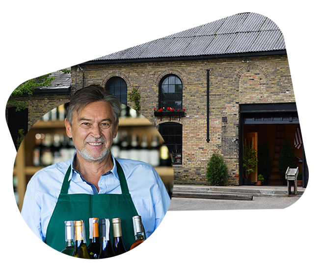 Smiling business owner over Traverse City scene, symbolizing insurance for individuals and small businesses.